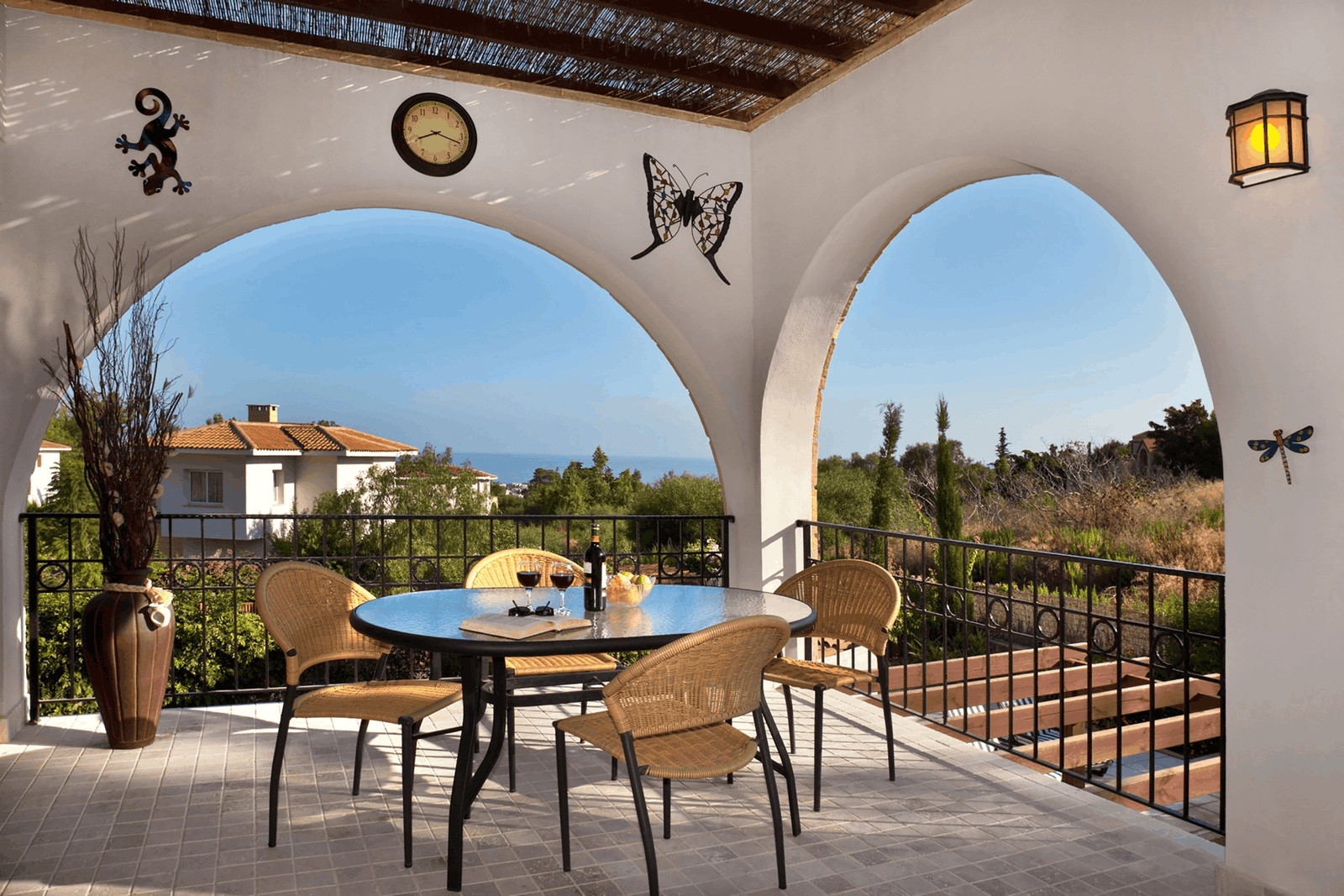 table-and-chairs-on-a-porch-overlooking-the-ocean-2026-03-24-14-12-15-utc